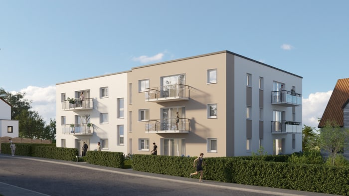 Zwei moderne Apartmentgebäude mit Balkonen, umgeben von Hecken und Bäumen, unter blauem Himmel.