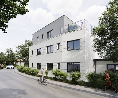 Modernes, graues und weißes Mehrfamilienhaus mit Flachdach und Dachterrasse, umgeben von Bäumen und einer Straße.