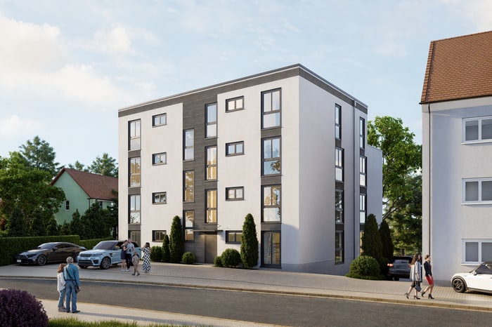 Modernes, weißes Wohngebäude mit grauen Akzenten und vielen Fenstern, Menschen gehen auf dem Bürgersteig.